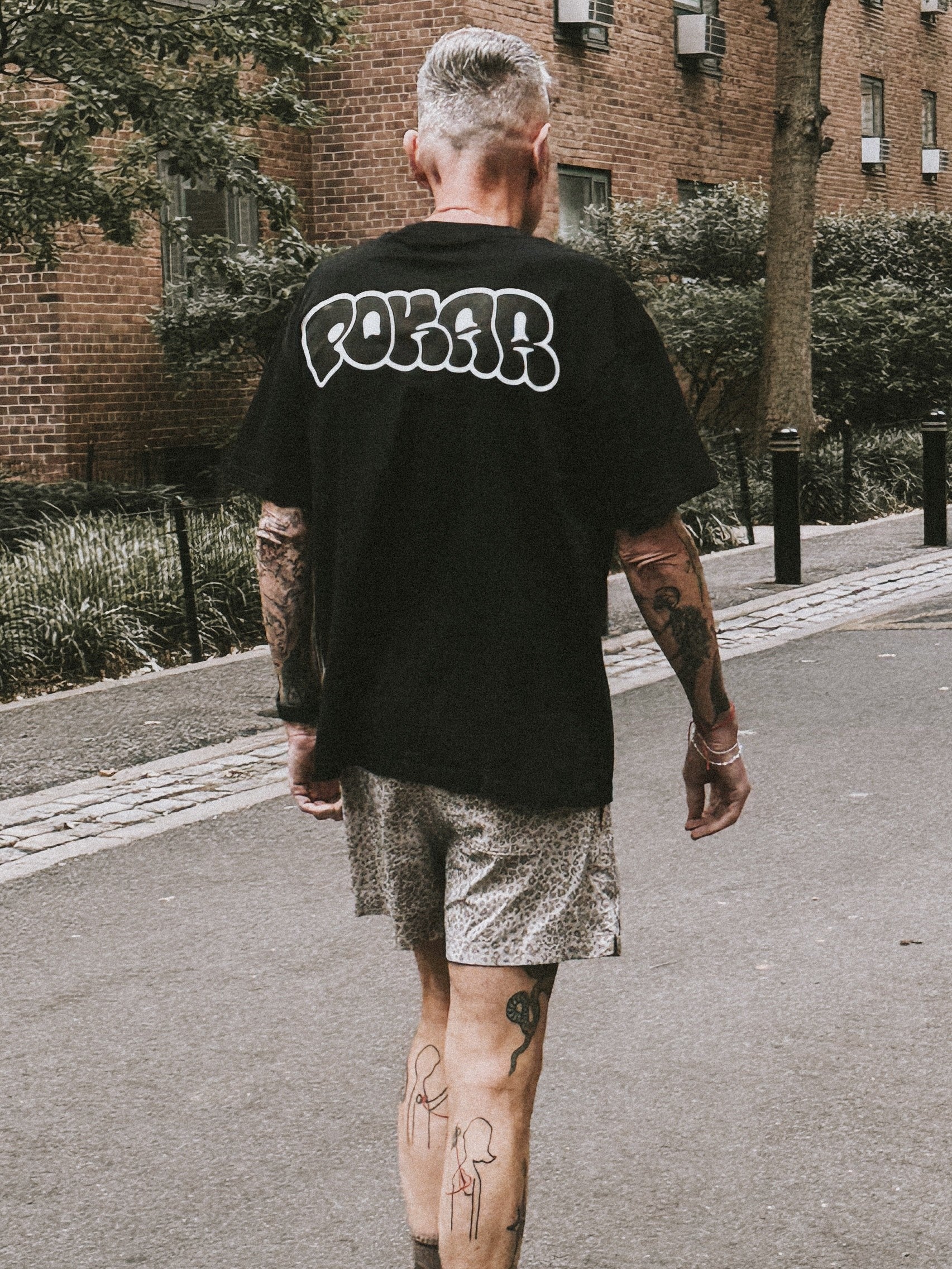 Back view of a POKAR black tee in New York